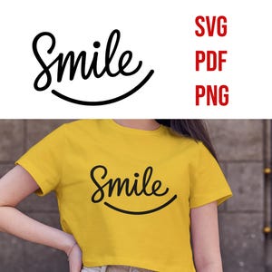 May include: A yellow t-shirt with the word "Smile" written in a black cursive font with a smile underneath.