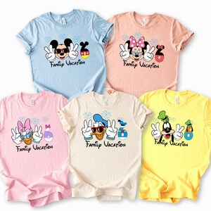 A collection of five t-shirts featuring Disney characters and the text "Family Vacation" printed on them.