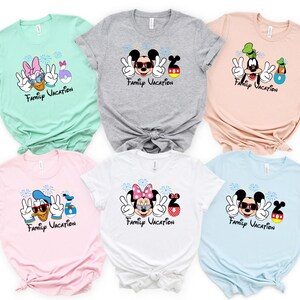 a collection of six t-shirts featuring Disney characters and the text "Family Vacation" printed on them.