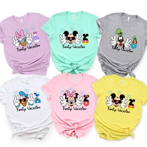 a collection of six t-shirts, each featuring a different Disney character and the text "Family Vacation" printed on them.