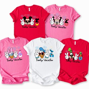 A collection of five t-shirts featuring Disney characters and the text "Family Vacation" printed on them.