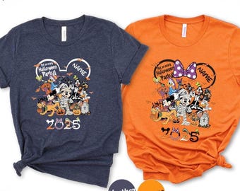 May include: Two Halloween-themed t-shirts, one navy blue and one orange. Each shirt features a graphic of Disney characters in Halloween costumes, with the text "Not so scary Halloween Party!" and "2025". The shirts have a Mickey Mouse ear design.
