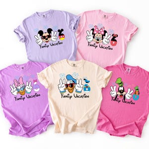 five t-shirts with Disney characters and the text "Family Vacation" printed on them.