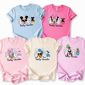 five t-shirts with Disney characters and the text "Family Vacation" printed on them.