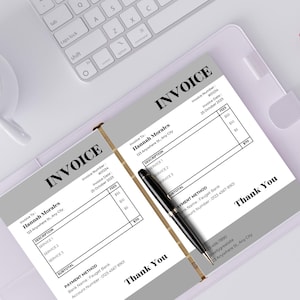 May include: Two invoices with the word "INVOICE" at the top, in a gray and white design. The invoices include details like invoice number, date, and service descriptions. A black pen rests on the documents, with a white keyboard and coffee cup in the background.