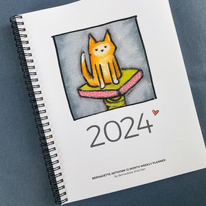 Last one! 2024 Spiral Weekly Planner by Bernadette Artwork – Full Color with cute illustrations, special days and holidays
