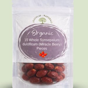 May include: A clear plastic pouch filled with 15 whole Synsepalum dulcificum (Miracle Berry) pieces. The pouch has a label with the word "Organic" and the brand name "Jostylin Naturals". The label also features a graphic of a tree and red berries.