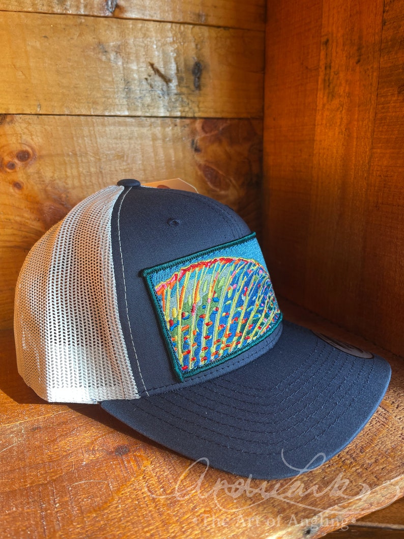 Andrea Larko Grayling Fin Embroidered Fly Fishing Trucker Snapbback Hat Side View on Navy with Gray Mesh Back