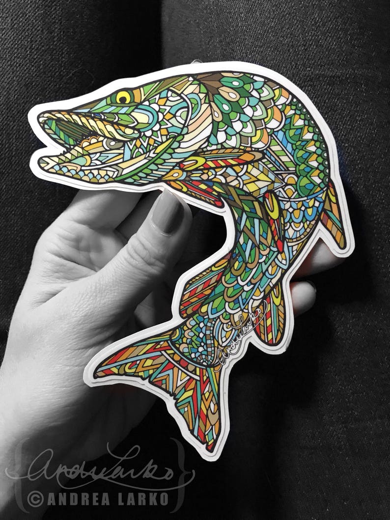 May include: A colorful, intricate, patterned sticker of a fish jumping out of the water. The fish is green, yellow, orange, red, and blue. The sticker is signed "Andrea Larko".