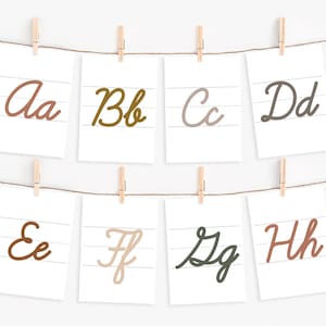 May include: Eight white cards with lined paper, each featuring a different letter of the alphabet in cursive. The letters are written in various colors, including brown, orange, green, and gray.