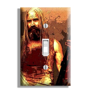 May include: A decorative light switch cover featuring a stylized image of a man with long blonde hair and a beard. The switch is in the "OFF" position. The background is a textured, sepia-toned design.