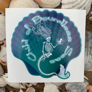 May include: A white sticker featuring a skeletal mermaid holding an octopus, with the text "Child of Boundless Seas" in a teal and blue seashell design. The mermaid has long flowing hair. The sticker is surrounded by seashells.