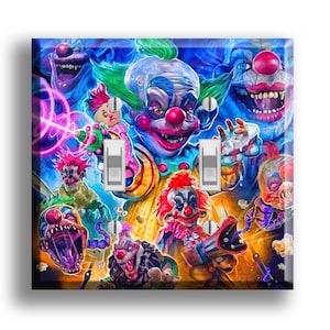 May include: A light switch cover featuring a vibrant, colorful illustration of multiple menacing clowns. The artwork includes various clown faces with exaggerated features, set against a blue and orange background. The cover has two light switch openings.