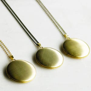 A selection of 3 examples of the large brass locket with different chain