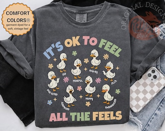 あらゆる感情を感じても大丈夫！おどけたガチョウの感情Tシャツ｜かわいい漫画の先生Tシャツ｜コンフォートカラーのメンタルヘルス啓発Tシャツ