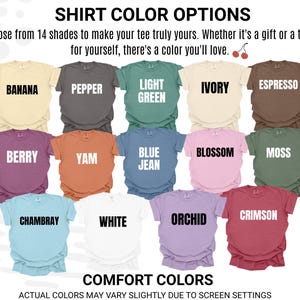 May include: A display of 14 different colored t-shirts, each labeled with a color name. Colors include Banana, Pepper, Light Green, Ivory, Espresso, Berry, Yam, Blue Jean, Blossom, Moss, Chambray, White, Orchid, and Crimson. The text reads "SHIRT COLOR OPTIONS".