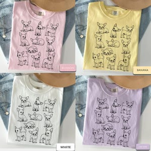 May include: A collection of four t-shirts in blossom pink, banana yellow, white, and orchid purple, each featuring a black line-art graphic print of twelve different chihuahua dogs in various poses, including sitting, standing, and lying down.