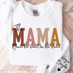 This Mama Wears Her Heart On Her Sleeve Sweatshirt, Personalized Mom Sweatshirt With Kids Names, Mothers Day Gifts,Custom Mother&#39;s Day Shirt