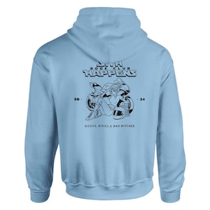 May include: Light blue hoodie with a black graphic print of a woman sitting on a motorcycle with the text "20th Book Club Happens 24" and "Books, Bikes, & Bad Bitches".