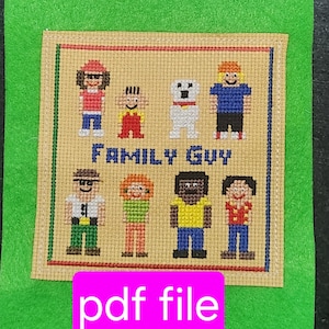 May include: A cross-stitch design featuring characters from the animated series "Family Guy." The design is set against a green felt background. The text "FAMILY GUY" is stitched above the characters. A pink rectangle at the bottom reads "pdf file."
