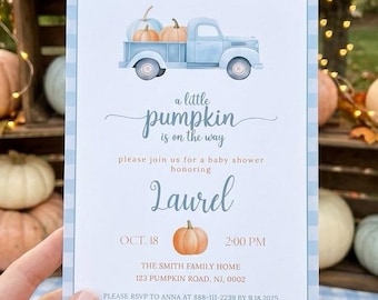 May include: A rectangular baby shower invitation card with a light blue gingham border. The design features a watercolor illustration of a light blue pickup truck carrying pumpkins, with the text: A little pumpkin is on the way, honoring Laurel, Oct. 18, 2:00 PM, The Smith Family Home, 123 Pumpkin Road, NJ, 0002, please RSVP to Anna at 888-111-2239 by 9.18.2025, registered at Amazon.com.