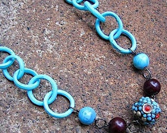 Beach Comber Necklace - recycled vintage silvertone metal & painted wood chain, brown and bright blue beads, focal pendant of seed beads