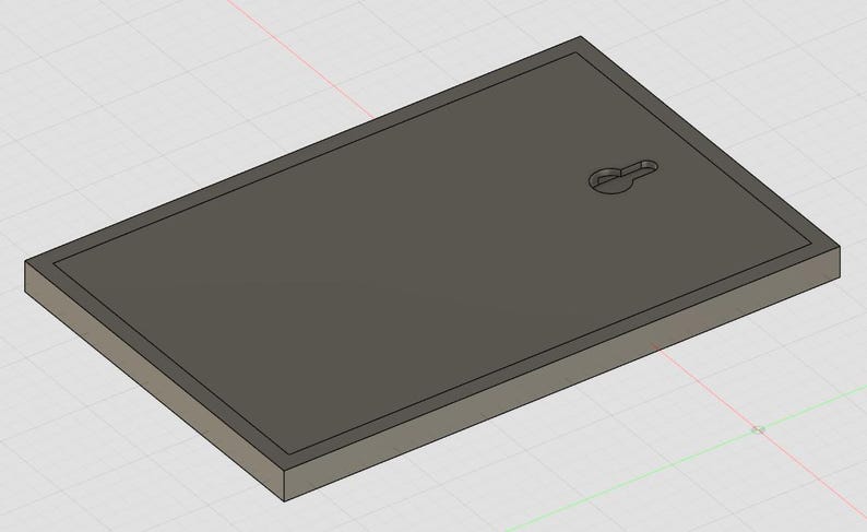 May include: A rectangular dark gray plaque with a beveled edge and a keyhole-shaped mounting slot centered near the top edge. The object has a flat, smooth surface and a solid, uniform appearance, presented in a three-dimensional digital render.