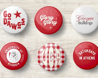 May include: A set of six circular pin-back buttons featuring University of Georgia themes. Designs include red text reading Go Dawgs, Glory Glory, Georgia Bulldogs, University of Georgia with a bulldog mascot, UGA in red gingham, and Saturdays in Athens.