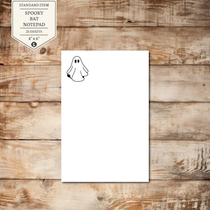 May include: A white notepad with a black ghost illustration in the upper right corner. The notepad is 4" x 6" and has 25 sheets. The top left corner has a label that says "STANDARD ITEM" and "SPOOKY BAT NOTEPAD".