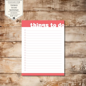May include: A white notepad with a coral border and the words "things to do" in a playful font. The notepad measures 4.25" x 5.5" and has a list of lined spaces for notes. A small label in the upper left corner reads "STANDARD ITEM".