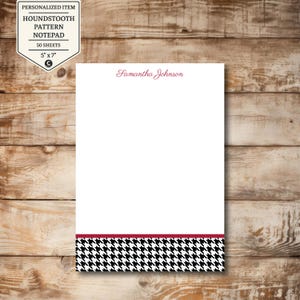 May include: White notepad with a houndstooth pattern border in black and white, accented with a thin burgundy stripe. The notepad is 5" x 7" and features the name "Samantha Johnson" in burgundy script. The top left corner has a label that reads "Personalized Item Houndstooth Pattern Notepad 50 Sheets".