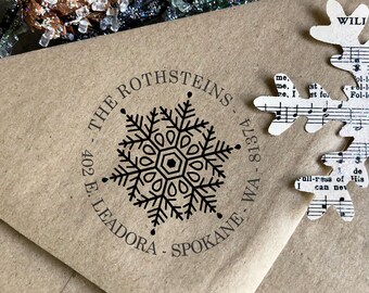 May include: A brown paper envelope with a black and white snowflake design rubber stamp. The stamp reads "The Rothsteins - 402 E. Leadora - Spokane, WA - 81374".