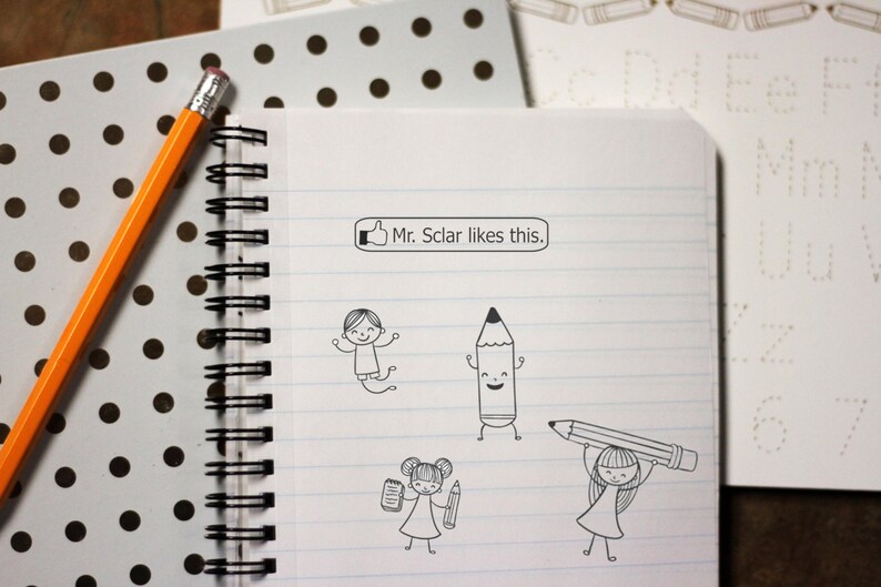 May include: A notebook with lined paper and cartoon pencil illustrations. The text "Mr. Sclar likes this." is in a speech bubble. An orange pencil and a polka dot notebook are also in the image.