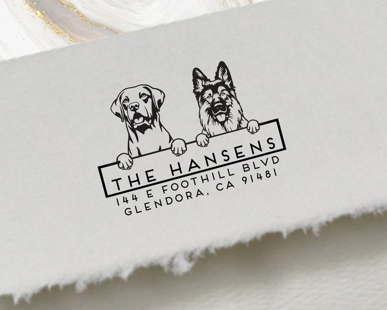 May include: Black and white illustration of two dogs peeking over a sign that reads "THE HANSENS 144 E FOOTHILL BLVD GLENDORA, CA 91481"