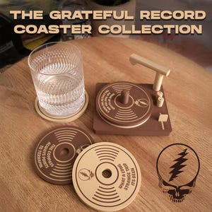 May include: The image showcases a collection of brown and tan record-themed coasters. One coaster features a miniature record player design. Other coasters display text and a lightning bolt skull graphic. A glass of water sits on a coaster. The text reads "THE GRATEFUL RECORD COASTER COLLECTION."