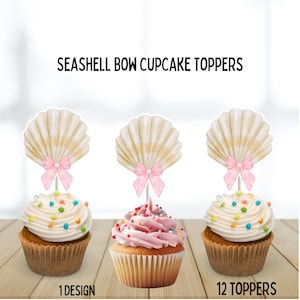 May include: Cupcakes with seashell bow toppers. The cupcakes have white and pink frosting with colourful sprinkles. The toppers are seashell-shaped with pink bows. The text on the image reads "Seashell Bow Cupcake Toppers", "1 Design", and "12 Toppers".
