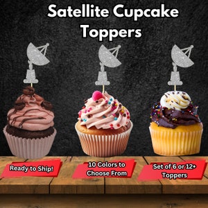 May include: Three cupcakes decorated with silver glitter satellite cupcake toppers. The cupcakes are frosted in pink, brown, and white. The text on the image reads "Satellite Cupcake Toppers", "Ready to Ship!", "10 Colours to Choose From", and "Set of 6 or 12+ Toppers".