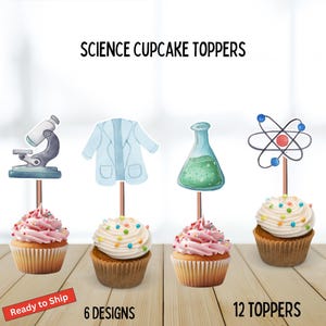 May include: Cupcakes with pink and white frosting, topped with colourful sprinkles. Each cupcake has a science-themed topper, including a microscope, lab coat, flask, and atom model. The text "SCIENCE CUPCAKE TOPPERS" is at the top.
