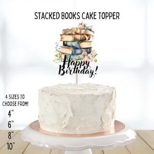 May include: A white frosted cake with a decorative cake topper. The topper features a stack of books with floral accents and the words "Happy Birthday!". The image also displays the text "4 SIZES TO CHOOSE FROM!" with size options of 4", 6", 8", and 10".