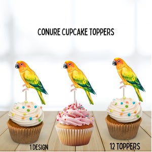 May include: Three cupcakes with colorful sprinkles and a yellow, green, and orange conure bird topper. The cupcakes sit on a wooden surface. The text "CONURE CUPCAKE TOPPERS" is at the top of the image.