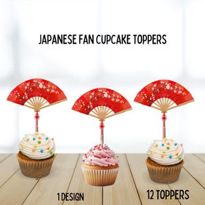 以下が含まれることがあります： 日本の扇子トッパーが付いた3つのカップケーキ。赤い扇子トッパーは花柄で、装飾的なスティックでカップケーキに取り付けられています。カップケーキは、白とピンクのフロスティングとカラフルなスプリンクルが付いています。「JAPANESE FAN CUPCAKE TOPPERS」と書かれたテキスト。