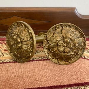 Vintage pair of brass circle curtain tie backs