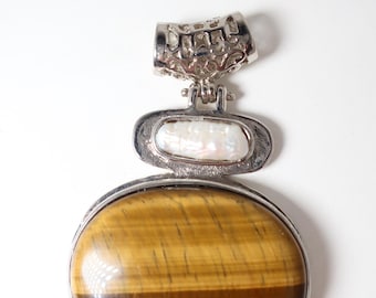 Silver tone with a Biwi pearl and large tiger eye stone.   2 1/2 in bale to the bottom and 1 3/4 in wide. This is a gorgeous piece.