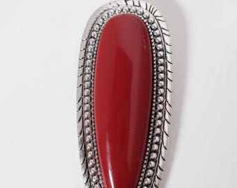 Silver tone and simulated red coral.  Oolala, expensive look without breaking the bank and it's upcycled.  This piece won't last long.