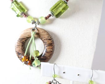 Peridot green glass beads with accents of wood and faux amber. Adjustable 16 to 19 inches.  Beautiful green to wear year round.