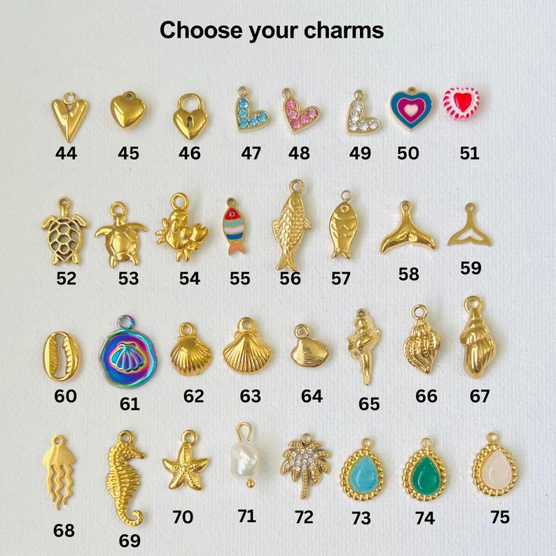 May include: A selection of gold-tone charms with various designs, including hearts, fish, seashells, and a starfish. The charms are numbered 44 through 75.