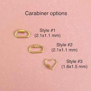 May include: Three gold-colored carabiner options. Style #1 and #2 are oval-shaped with a 2.1 cm by 1.1 cm size. Style #3 is heart-shaped with a 1.6 cm by 1.5 cm size.