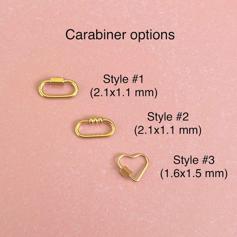 May include: Three gold-colored carabiner options. Style #1 and #2 are oval-shaped with a 2.1 cm by 1.1 cm size. Style #3 is heart-shaped with a 1.6 cm by 1.5 cm size.