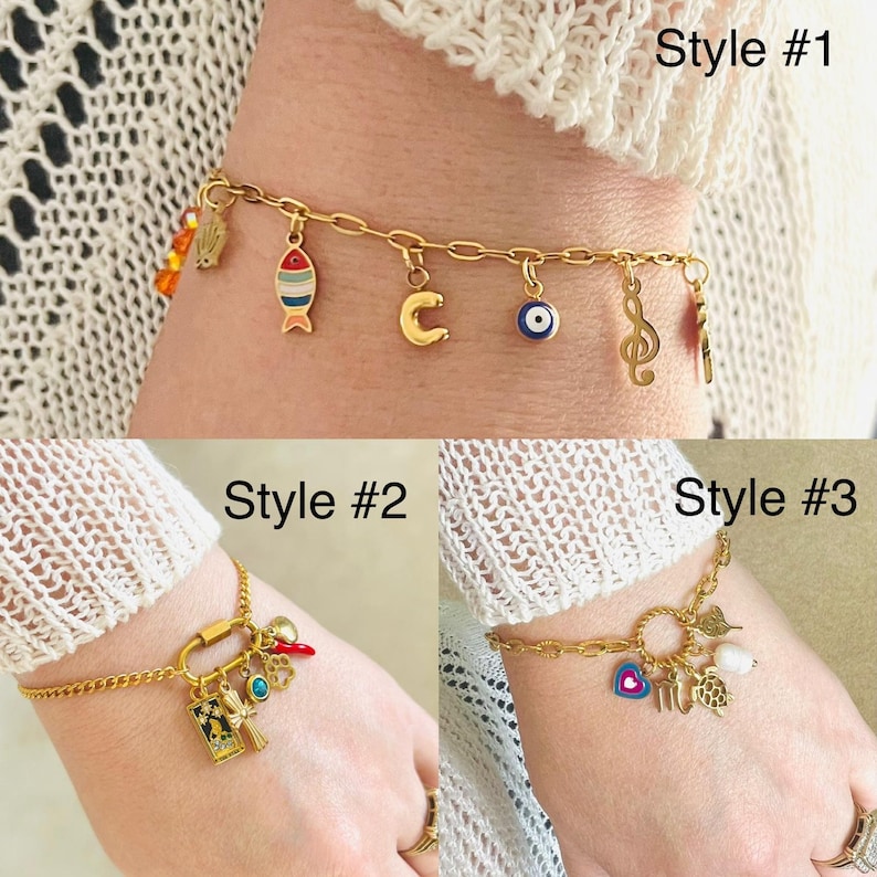 May include: Three gold charm bracelets with different charms. The first bracelet has a fish, a letter C, an evil eye, and a music note charm. The second bracelet has a padlock, a red chili pepper, a green gem, and a small book charm. The third bracelet has a circle charm, a heart, a turtle, and a pearl charm.