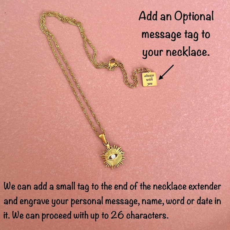 May include: A gold-tone chain necklace featuring a sunburst pendant with a central clear stone. The necklace includes an extender chain with a small square tag engraved with the text "always with you." Text on image: Add an Optional message tag to your necklace.